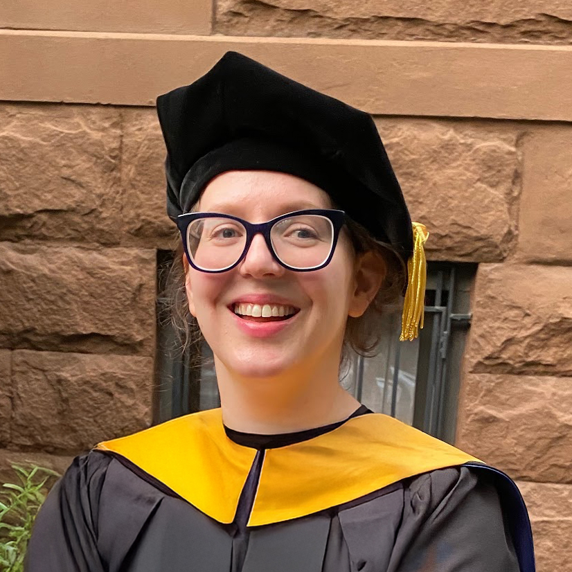 Dr. E smiling in a warm, bright setting